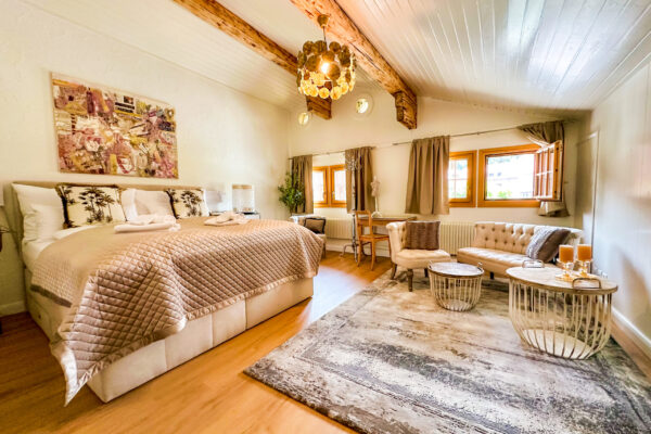 Chalet Simmi-62 Chalet Simmi in Wimis in der Schweiz: Schalfzimmer, geräumiges Gästezimmer, ein kuscheliges Bett mit warmen Licht, einer Couch, Kerzen, Tischen